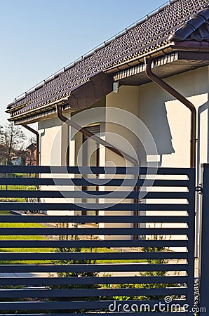 Modern private house with horizontal bars grey steel fence Stock Photo