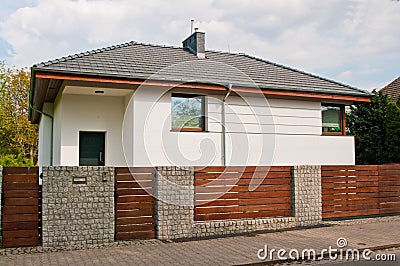 Modern private house with horizontal bars grey steel fence Stock Photo