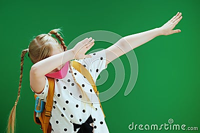 Modern pupil dabbing against green Stock Photo