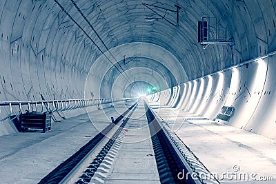 Modern railway tunnel with green signal light Stock Photo