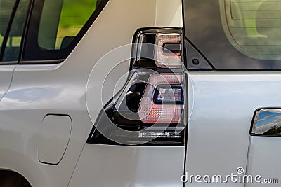 Modern rear light of a car. Brake light and arrow of large suv. Stock Photo