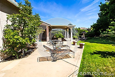 Modern Rear Yard With Covered Patio & Outdoor Furniture Stock Photo