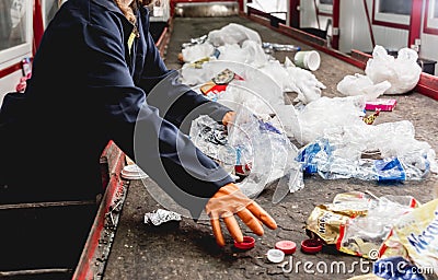 At modern recycling plant. Separate garbage collection. Workers sorting trash Stock Photo