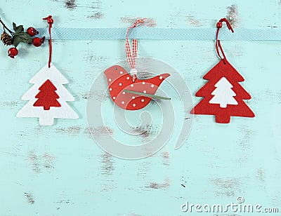 Modern red and white Christmas hanging bird and tree decorations on aqua blue wood background. Stock Photo