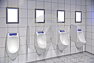 Modern restroom interior with urinal row Stock Photo