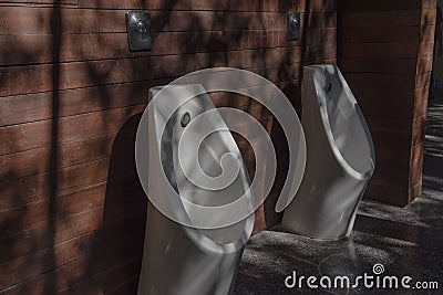 Modern restroom with urinal row . Stock Photo
