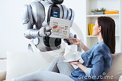 Modern robot holding laptop Stock Photo