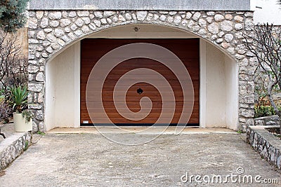 Modern roll up metal garage door with faux wood grain finish Stock Photo