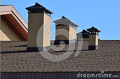 Modern roofing and decoration of chimneys. Flexible bitumen or slate shingles. The absence of corrosion and condensation due to t Stock Photo