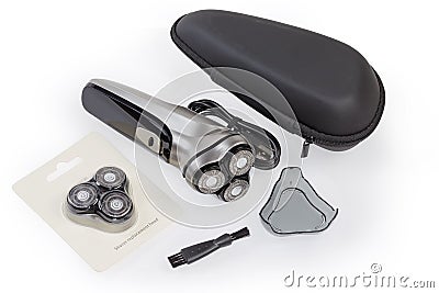 Modern rotary electric shaver and accessories on a white surface Stock Photo