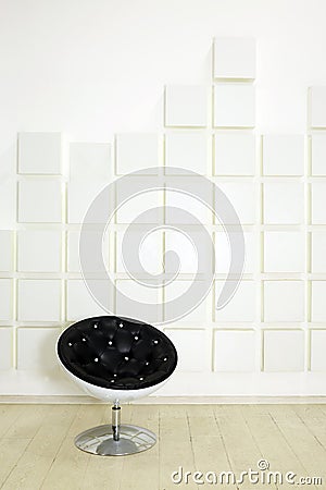 Modern round black leather armchair in empty room Stock Photo