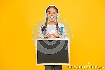 Modern school life. Schoolgirl pupil informing you. School girl hold blank chalkboard copy space. Announcement and Stock Photo