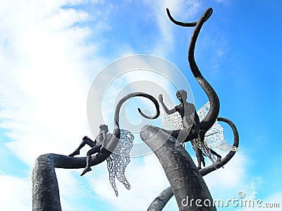 Modern sculptural composition - boys with wings on trees in Kutaisi, Georgia Stock Photo