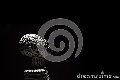 Modern sculpture of a man looking up, on a black background. Editorial Stock Photo