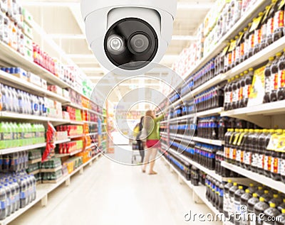 Modern security camera on monitoring the supermarket with blurred blackground Stock Photo