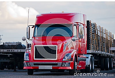 Modern semi truck flat bed trailer with cargo on parking lot Stock Photo