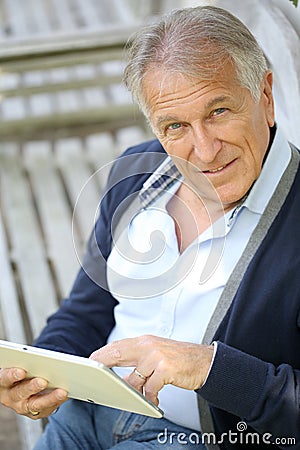 Modern senior man websurfing Stock Photo