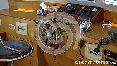 Modern ship control panel with steering wheel and engine accelerators on the captain bridge Editorial Stock Photo