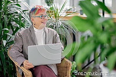 Happy successful business lady sitting with laptop Stock Photo