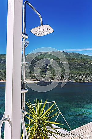 Modern shower on a luxurious beach in a beautiful lagoon on a sunny day. Stock Photo