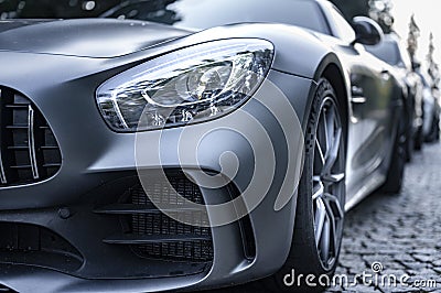 Modern silver car parking on the road. Close up. Headlights detail. Stock Photo