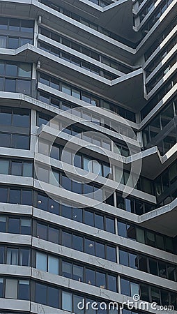 Modern skyscraper with angular overhangs and recessed windows playing with light and shadow Stock Photo