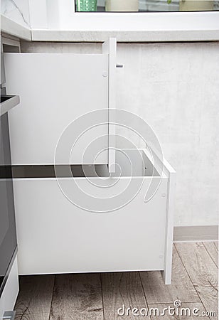 Modern sliding drawer system in the kitchen. Production of kitchen furniture. Ergonomics and design, close-up Stock Photo