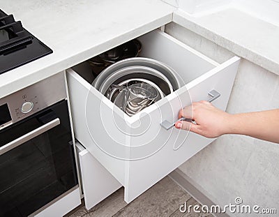 Modern sliding drawer system in the kitchen. Production of kitchen furniture. Ergonomics and design, close-up Stock Photo