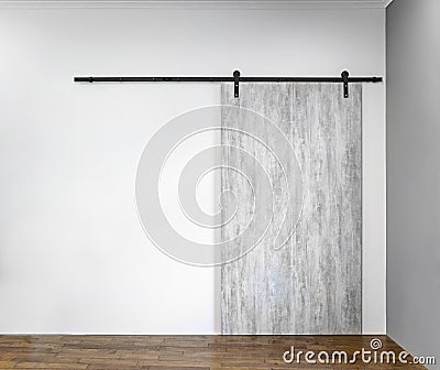 Modern sliding gray door on white wall Stock Photo