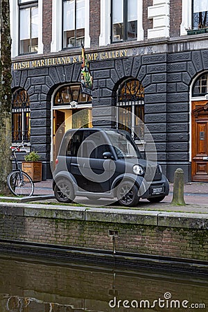 Modern small electric car Amsterdam in front of Hash Marihuana Museum Editorial Stock Photo