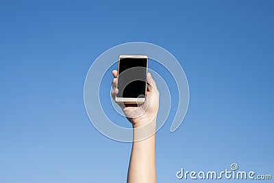 Modern smartphone with blank screen.Happy people showing modern mobile phones against blue sky Stock Photo