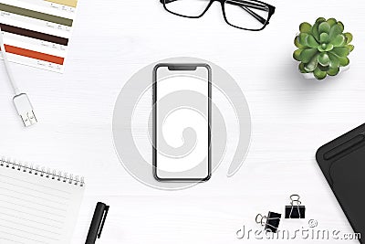 Modern smartphone mockup on a desk surrounded by supplies Stock Photo