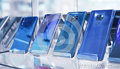 Modern smartphones in electronics store. Technology, Business Stock Photo