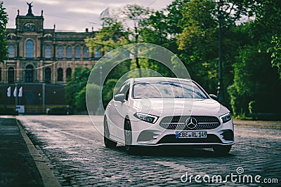 Modern sporty car of Mercedes benz brand drives in front of old architecture in Munich Editorial Stock Photo