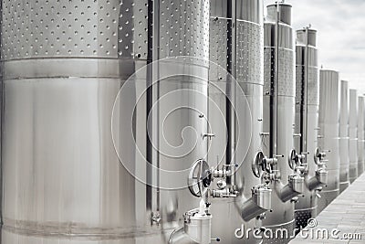 Modern stainless steel barrels for wine fermentation at a winery. Wine industry. Stock Photo