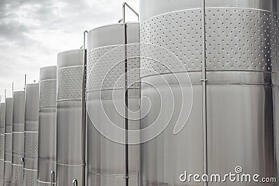 Modern stainless steel barrels for wine fermentation at a winery. Wine industry. Stock Photo