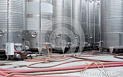 Modern stainless steel barrels for wine fermentation at a winery. Wine industry. Stock Photo