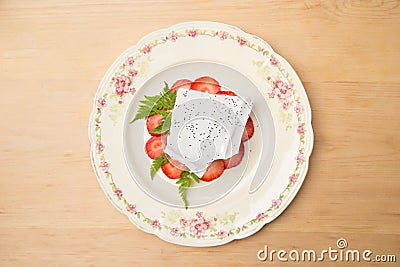 Modern strawberry rhubarb cheesecake dessert with a meringue wafer. Stock Photo