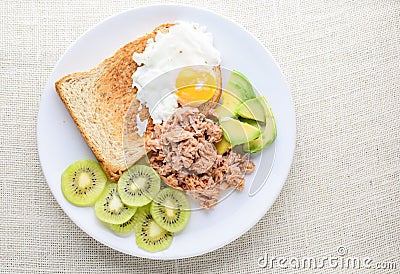 Modern style clean food, bread, egg, tuna salad, kiwi and avocado Stock Photo