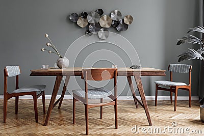 Stylish dining room with wooden table and vintage chairs. Stock Photo