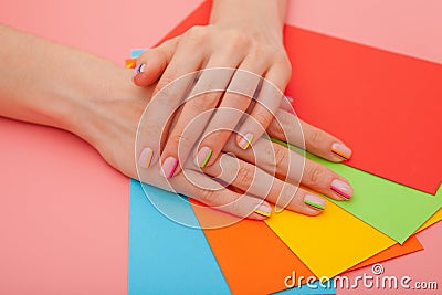 Modern stylish manicure rainbow or summer mood, on a pink table with color envelopes. Close-up Stock Photo