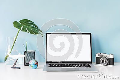 Modern and stylish workspace mock up with blank laptop and desk office supplies with color background and copy space Stock Photo