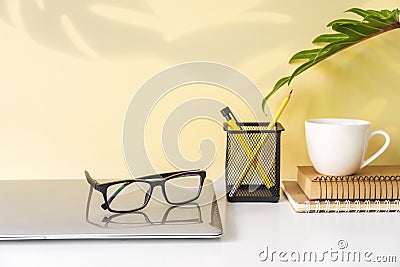 Modern and stylish workspace mock up with laptop and desk office supplies with color background and copy space Stock Photo