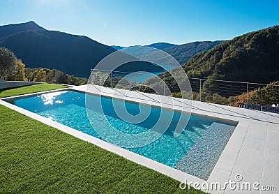 Modern swimming pool in the garden with lake and valley view Stock Photo