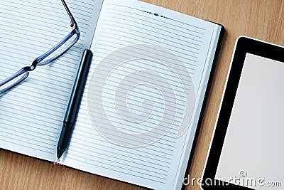 Modern tablet PC next to a classical open agenda Stock Photo