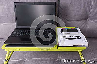 Modern tabletop workstation on a couch Stock Photo