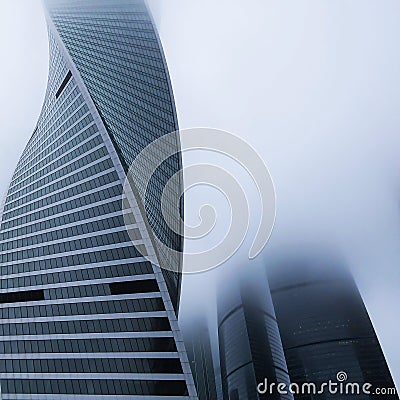 Modern tall skyscraper in dense fog, closeup. Square cropping Stock Photo