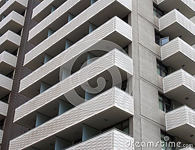 modern tall white concrete apartment block with geometric angular balconies Stock Photo