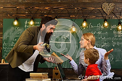 Modern teacher hipster writing on big blackboard with math formula, Teacher respects students, Professor and school Stock Photo