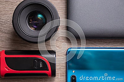 Modern technology flat lay, laptop, camera lens, vaping device and blue smartphone Stock Photo